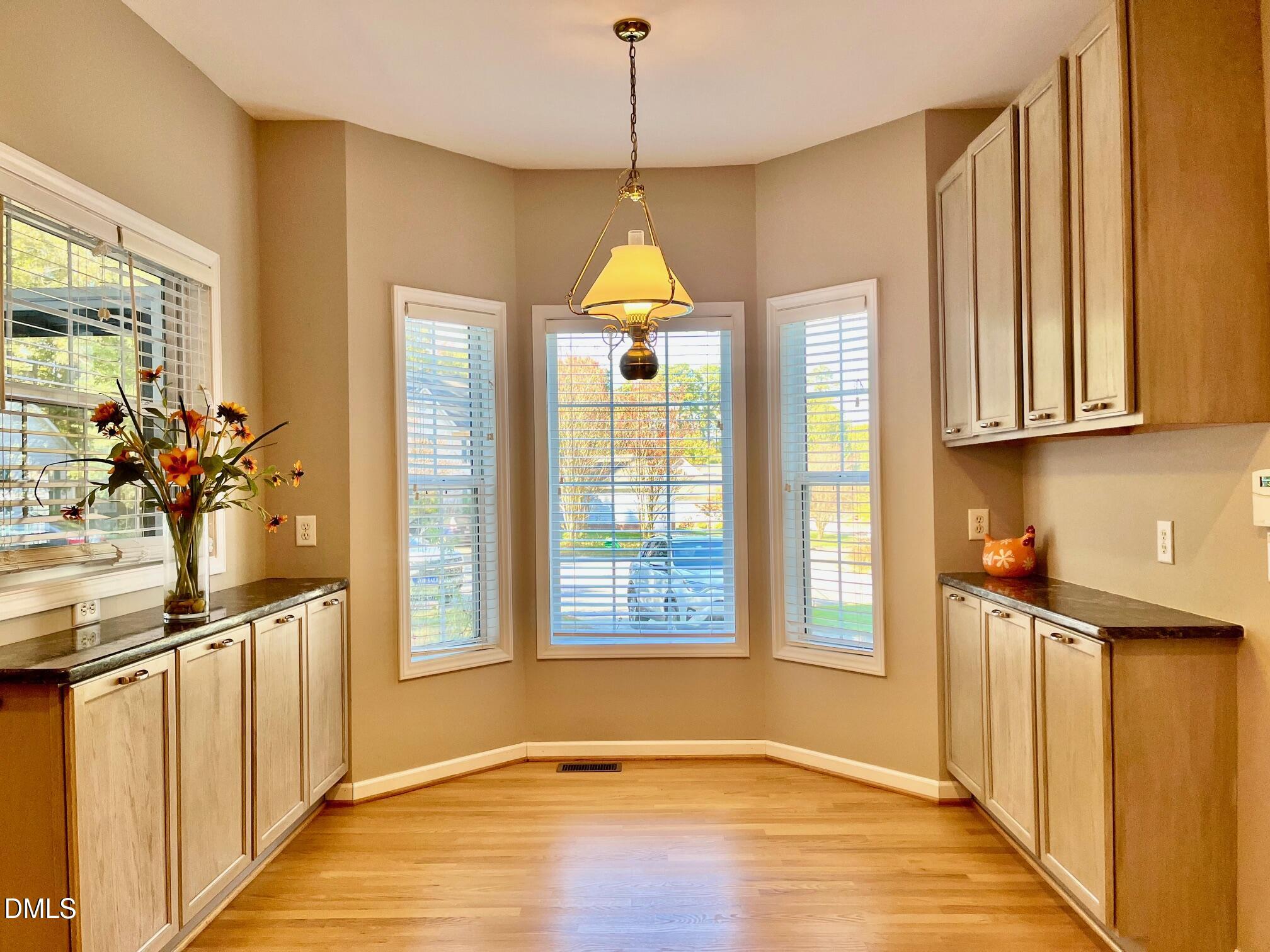 3027 Rennit Court Raleigh, NC 27603 - Photo 8 of 29 a kitchen with stainless steel appliances granite countertop a stove a sink and a window