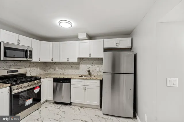 a kitchen with a refrigerator sink and microwave