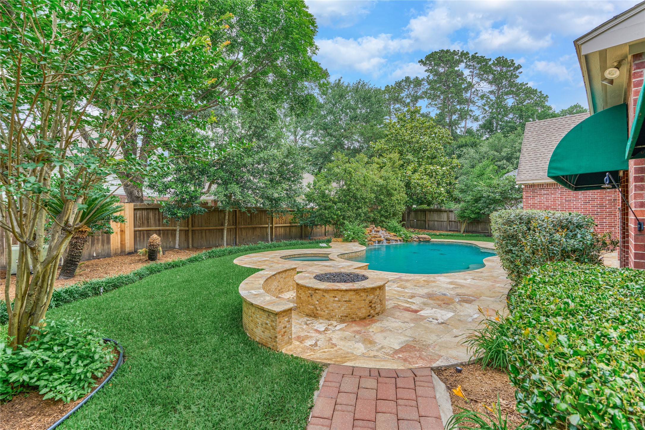 7 Gentry Oak Court Spring, TX 77381 - Photo 41 of 50 a view of a backyard with table and chairs potted plants and large tree