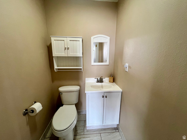 640 West Cyn Road Ferron, UT 84523 - Photo 20 of 45 Half bath with vanity and light marble finish floors on the main level