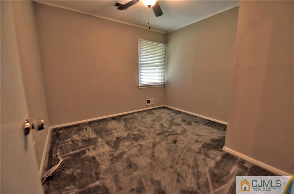 15 Burnham Road East Brunswick, NJ 08816 - Photo 11 of 16 a view of a hallway with a window