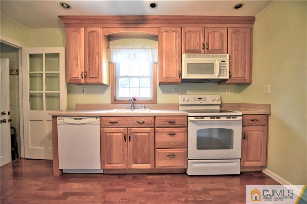 15 Burnham Road East Brunswick, NJ 08816 - Photo 12 of 16 a kitchen with stainless steel appliances a stove a sink and a microwave