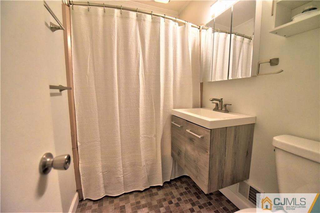 15 Burnham Road East Brunswick, NJ 08816 - Photo 13 of 16 a bathroom with a sink a toilet and shower
