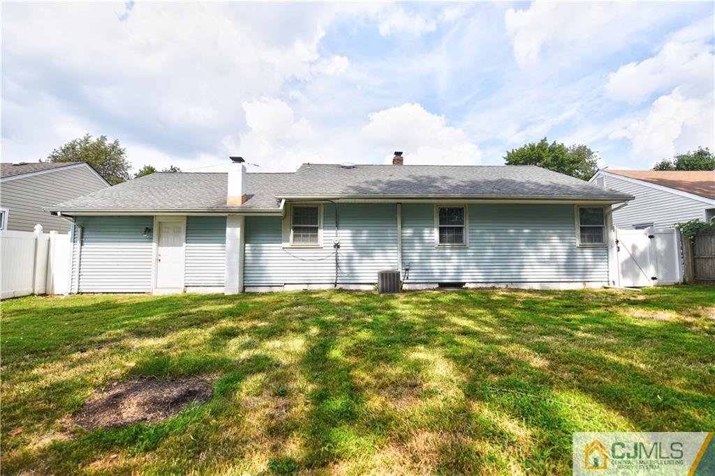 15 Burnham Road East Brunswick, NJ 08816 - Photo 15 of 16 a view of a brick house with a yard