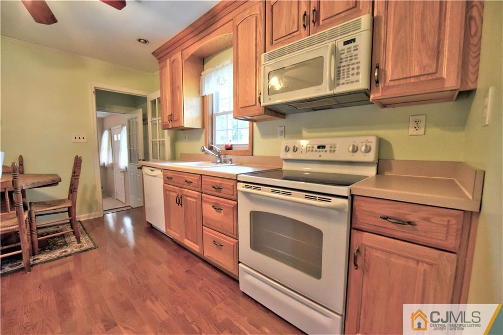 15 Burnham Road East Brunswick, NJ 08816 - Photo 5 of 16 a kitchen with a stove oven and white cabinets