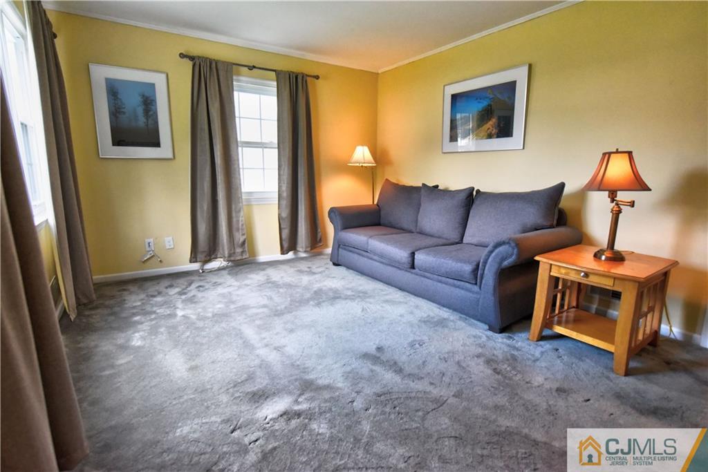 15 Burnham Road East Brunswick, NJ 08816 - Photo 7 of 16 a living room with furniture and a window
