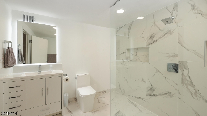22 Riverside Drive, Unit B 7 Cranford, NJ 07016 - Photo 15 of 24 a bathroom with a sink toilet and shower