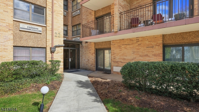 22 Riverside Drive, Unit B 7 Cranford, NJ 07016 - Photo 20 of 24 a front view of a building with a garden