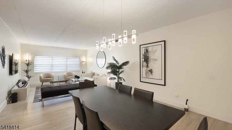 22 Riverside Drive, Unit B 7 Cranford, NJ 07016 - Photo 3 of 24 a living room with furniture and a chandelier