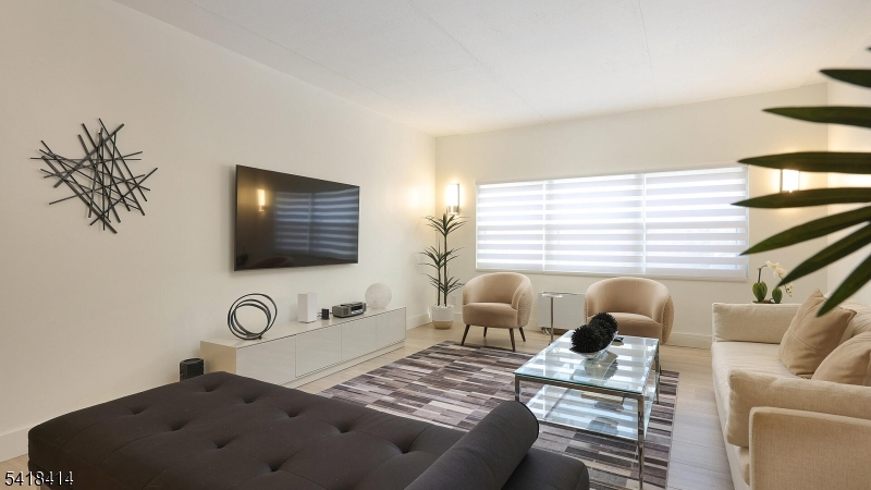 22 Riverside Drive, Unit B 7 Cranford, NJ 07016 - Photo 6 of 24 a living room with furniture and a flat screen tv