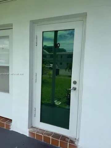 a bathroom with a glass shower door and a sink