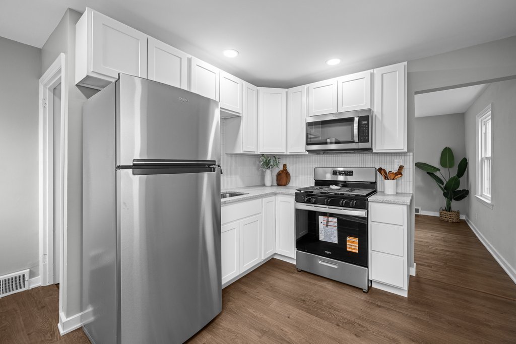 2036 46th Street Rock Island, IL 61201 - Photo 6 of 24 a kitchen with cabinets stainless steel appliances and wooden floor
