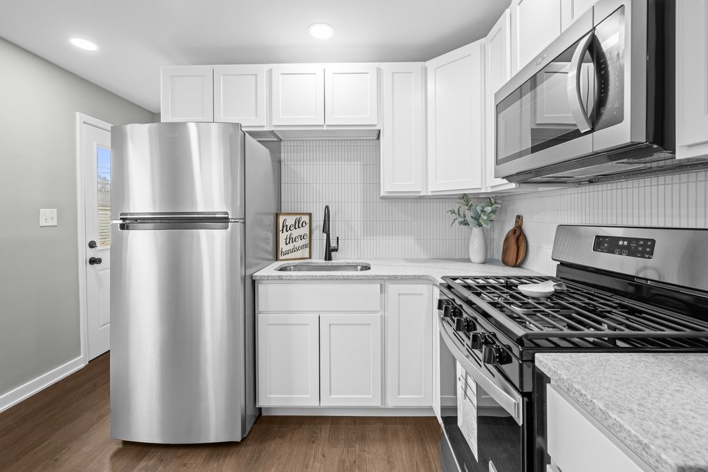 2036 46th Street Rock Island, IL 61201 - Photo 8 of 24 a kitchen with stainless steel appliances granite countertop a stove a refrigerator and a microwave