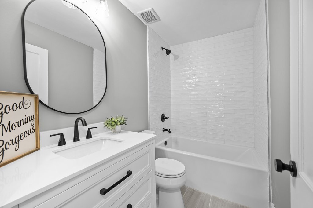 2036 46th Street Rock Island, IL 61201 - Photo 9 of 24 a bathroom with a sink a toilet and a mirror