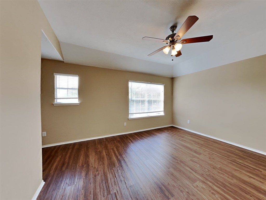 14427 Brunswick Point Lane Houston, TX 77047 - Photo 11 of 20 a view of an empty room with wooden floor and a window