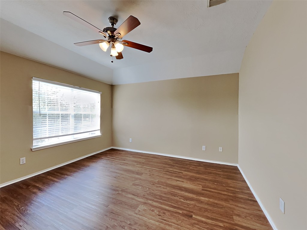 14427 Brunswick Point Lane Houston, TX 77047 - Photo 12 of 20 a view of an empty room with wooden floor and a window