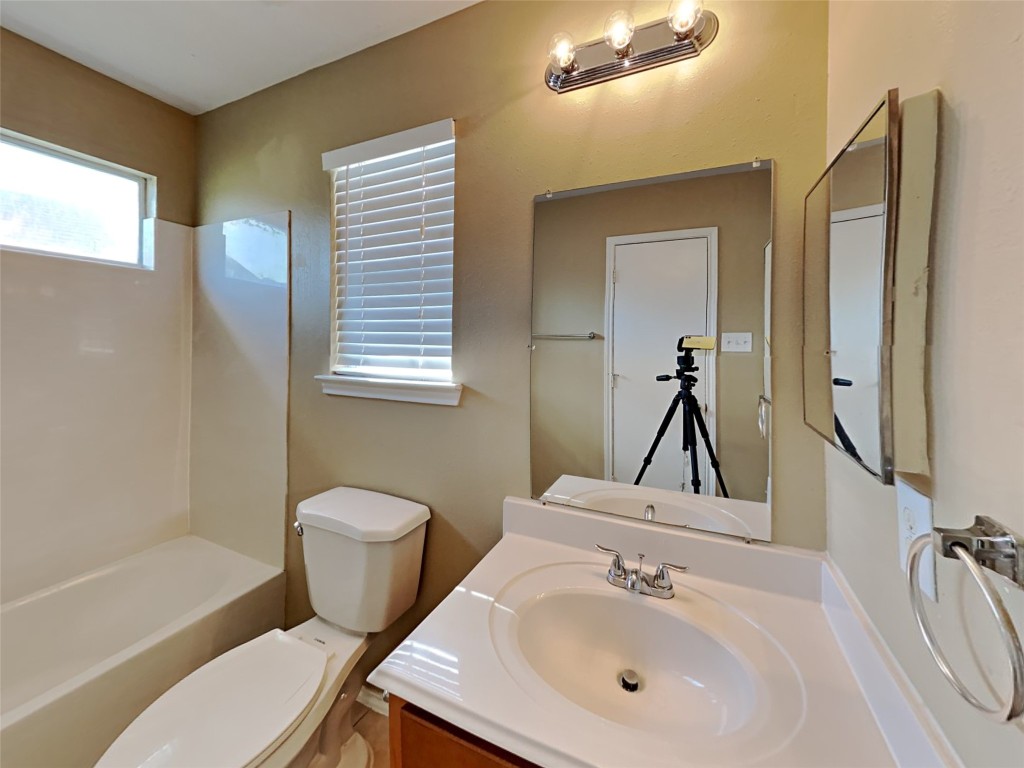 14427 Brunswick Point Lane Houston, TX 77047 - Photo 13 of 20 a bathroom with a toilet sink and mirror