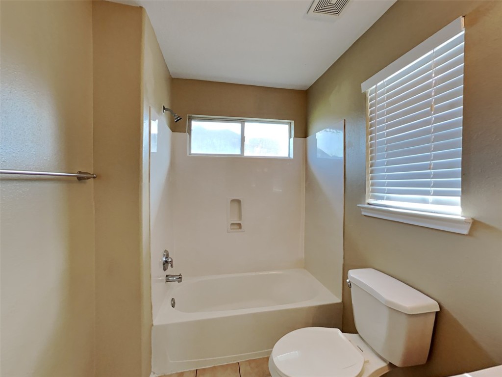 14427 Brunswick Point Lane Houston, TX 77047 - Photo 14 of 20 a bathroom with a toilet and a bathtub
