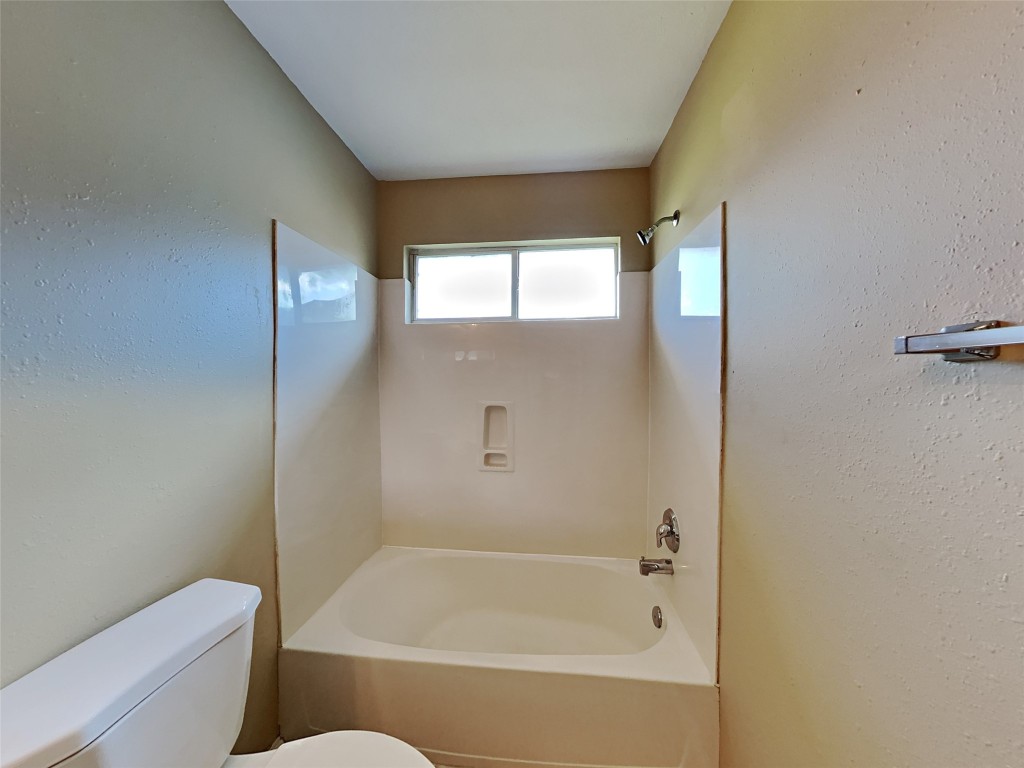 14427 Brunswick Point Lane Houston, TX 77047 - Photo 18 of 20 a bathroom with a bathtub and a toilet