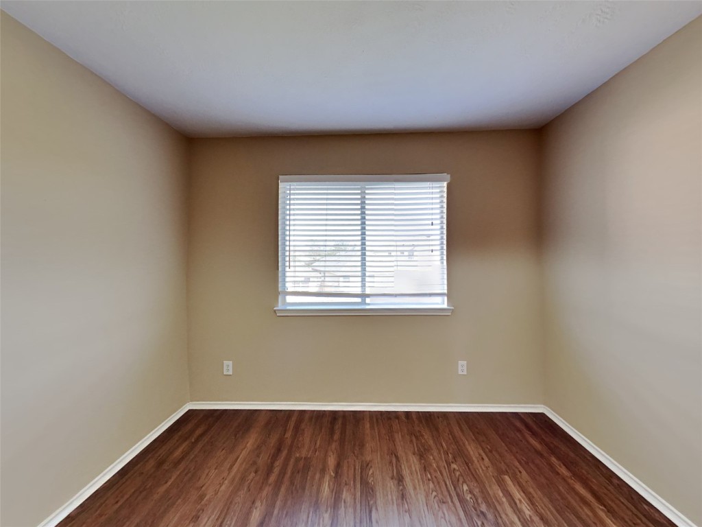 14427 Brunswick Point Lane Houston, TX 77047 - Photo 19 of 20 an empty room with wooden floor and windows