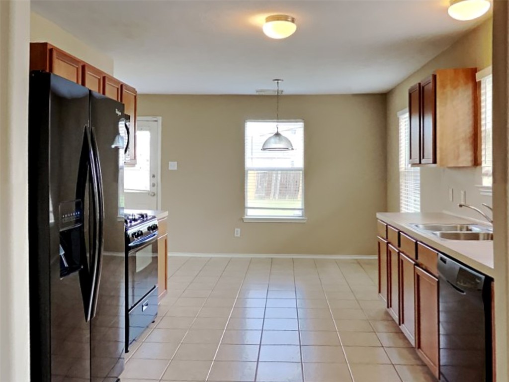 14427 Brunswick Point Lane Houston, TX 77047 - Photo 3 of 20 a kitchen with stainless steel appliances granite countertop a refrigerator and a sink
