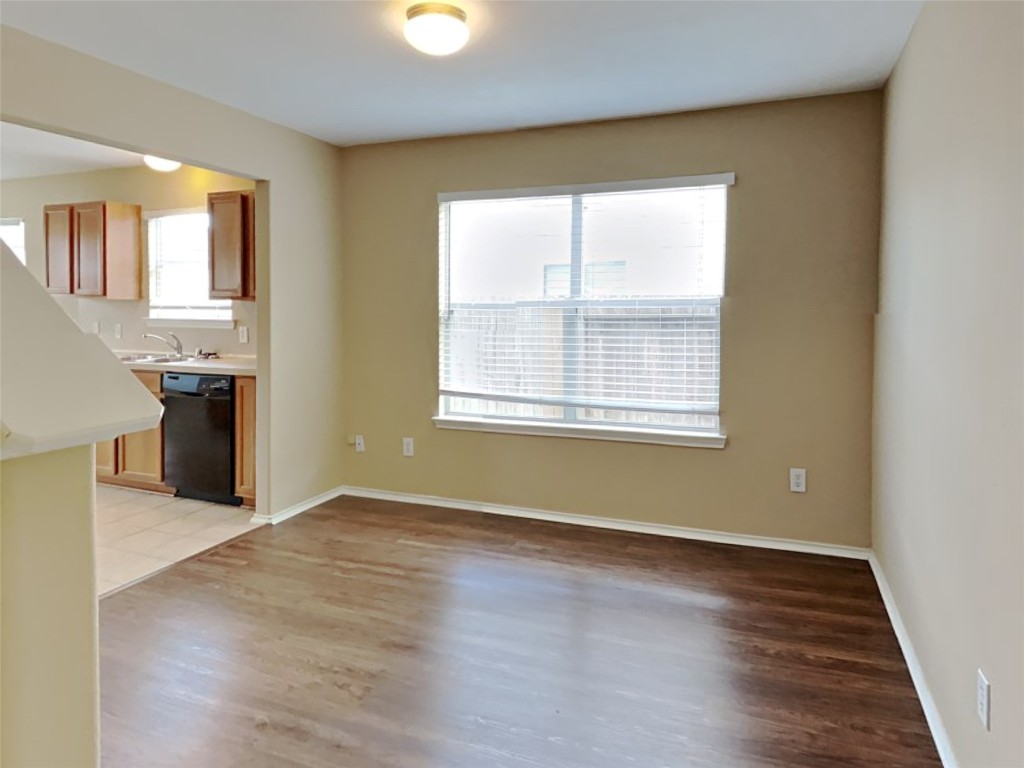 14427 Brunswick Point Lane Houston, TX 77047 - Photo 5 of 20 an empty room with wooden floor and windows