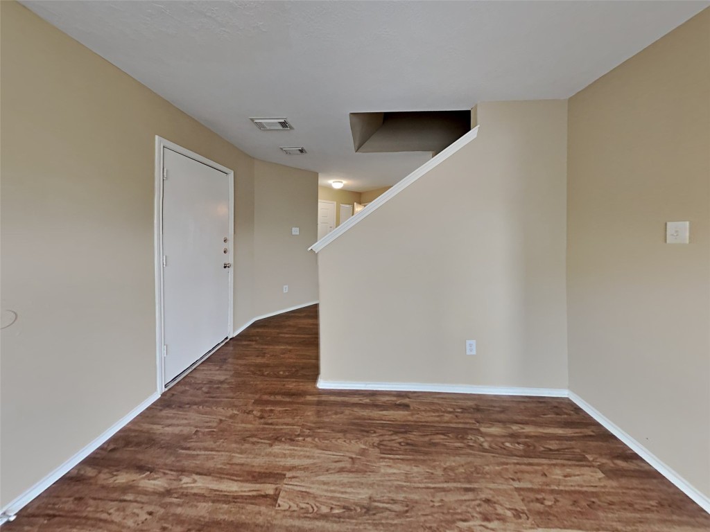 14427 Brunswick Point Lane Houston, TX 77047 - Photo 6 of 20 a view of an empty room with wooden floor