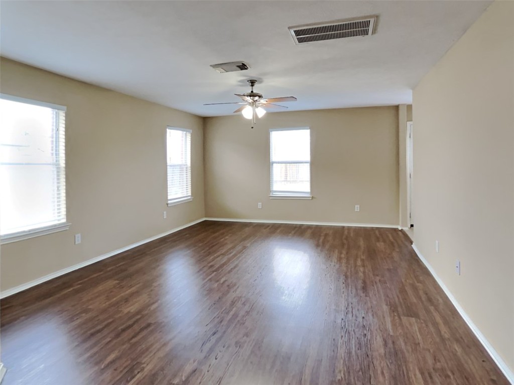 14427 Brunswick Point Lane Houston, TX 77047 - Photo 7 of 20 an empty room with wooden floor and windows