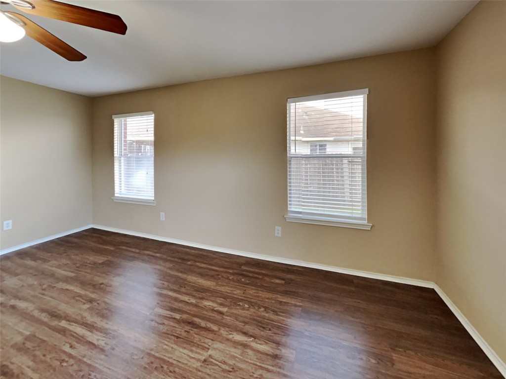 14427 Brunswick Point Lane Houston, TX 77047 - Photo 8 of 20 a view of an empty room with wooden floor and a window