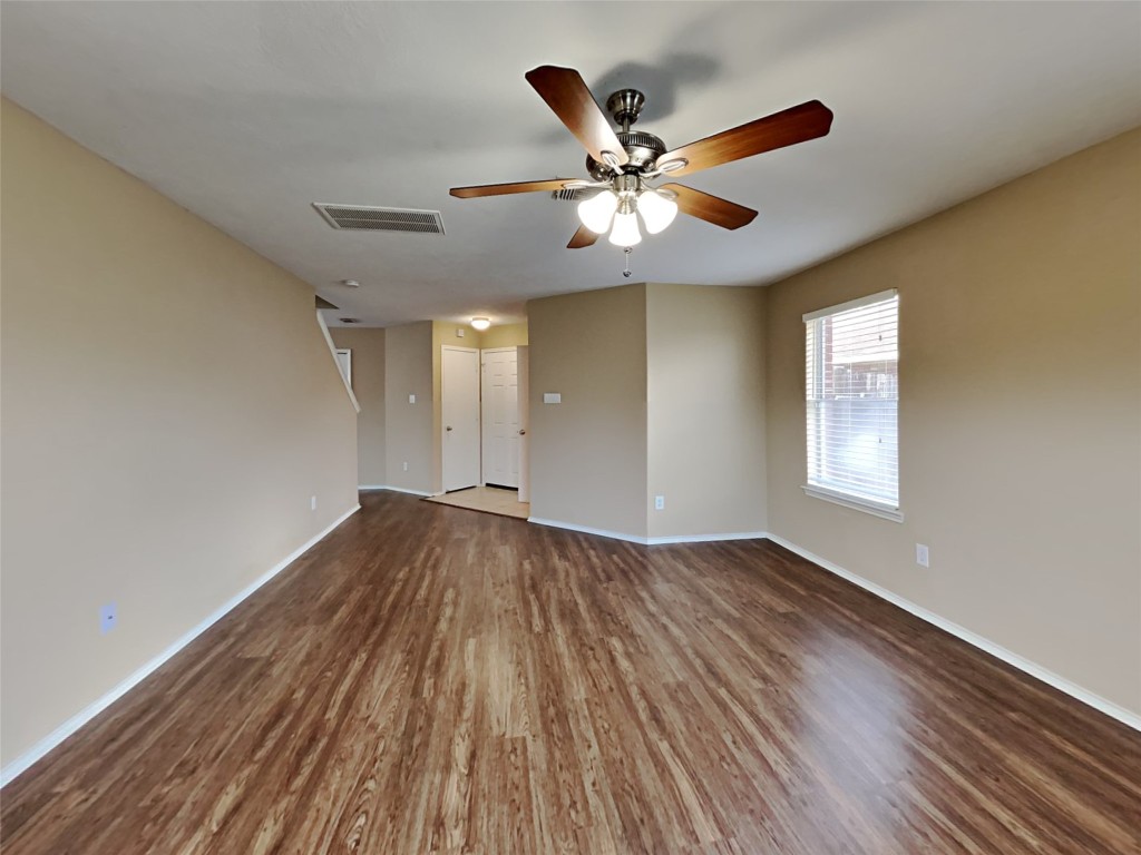 14427 Brunswick Point Lane Houston, TX 77047 - Photo 9 of 20 a view of an empty room with wooden floor and a window