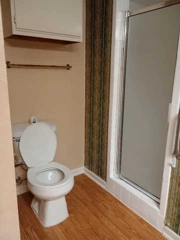 a white toilet sitting next to a bathroom sink