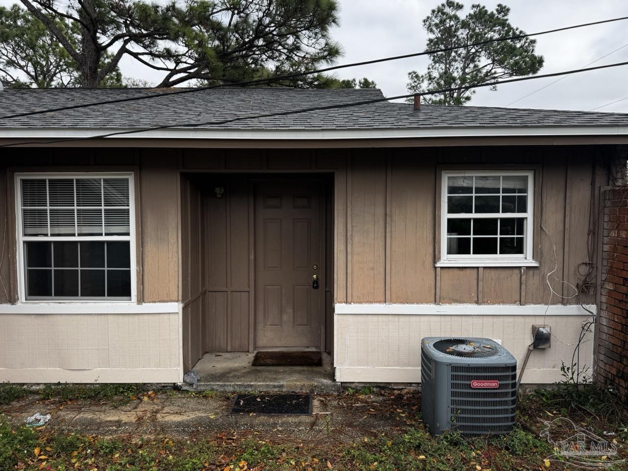 a front view of a house with a garden