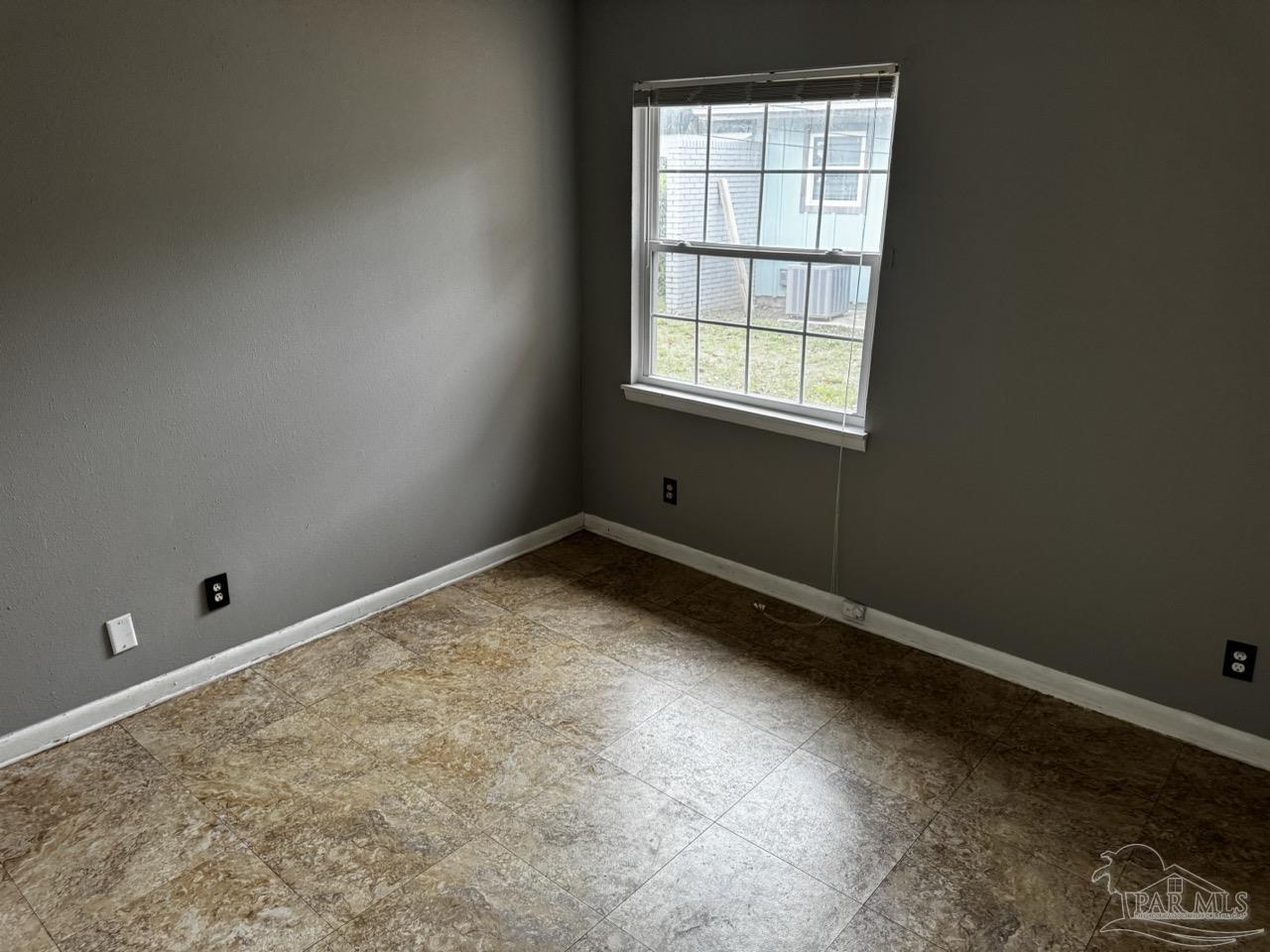 1460 Bakalane Court, Unit A Pensacola, FL 32504 - Photo 13 of 24 an empty room with a window