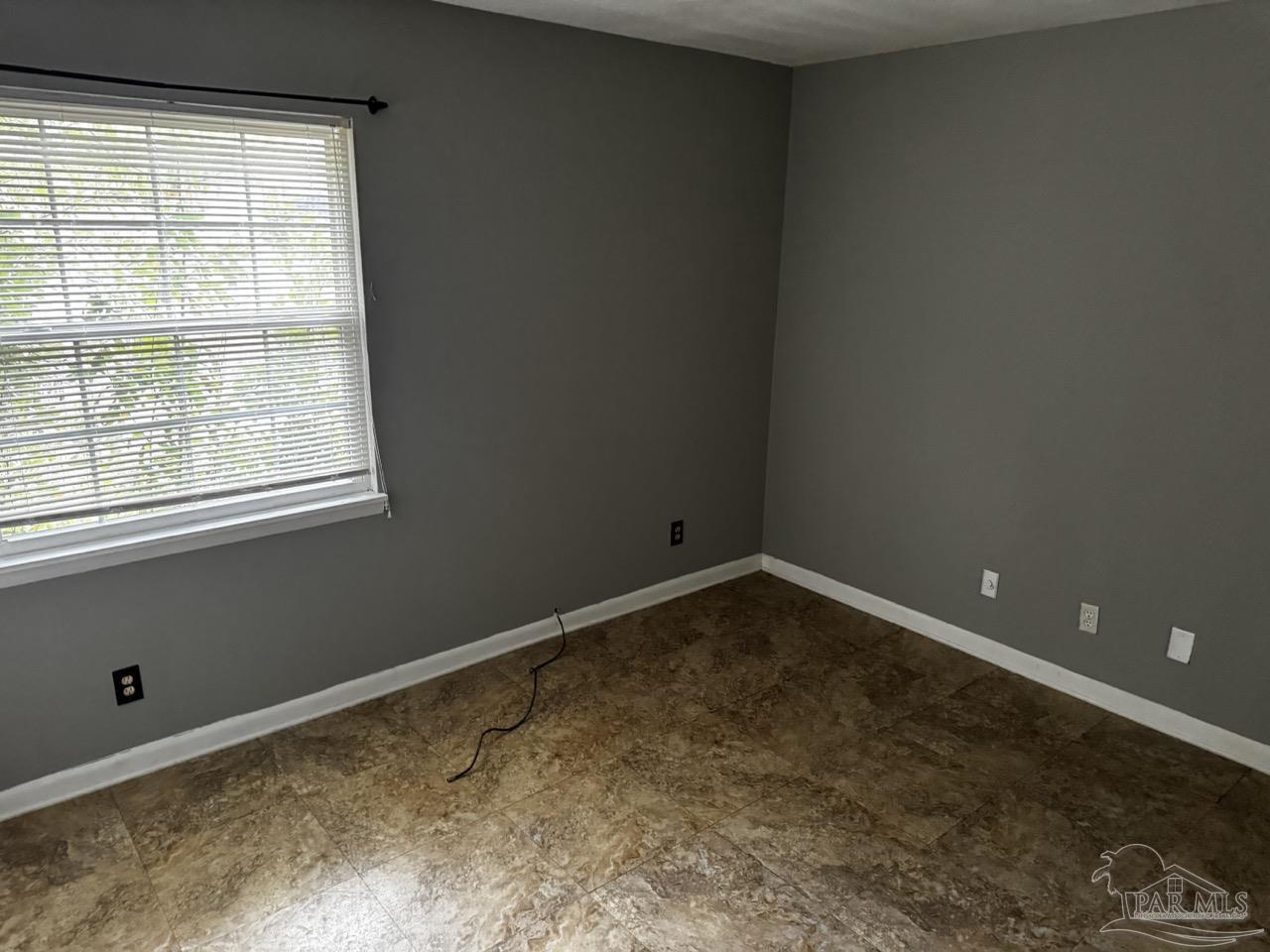 1460 Bakalane Court, Unit A Pensacola, FL 32504 - Photo 18 of 24 a room with a empty space and a window