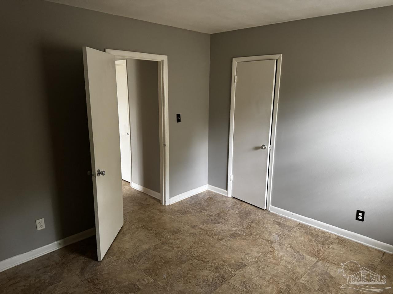 1460 Bakalane Court, Unit A Pensacola, FL 32504 - Photo 19 of 24 an empty room with closet and a bathroom