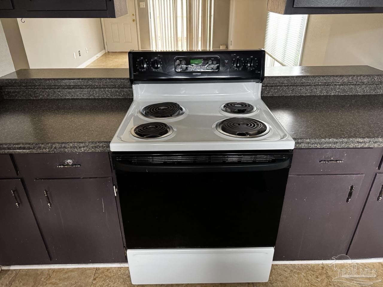 1460 Bakalane Court, Unit A Pensacola, FL 32504 - Photo 4 of 24 a kitchen with a stove and a microwave