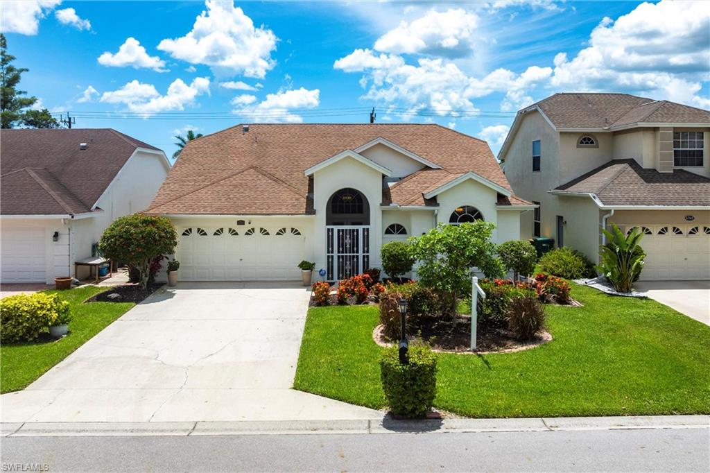6769 Berwick Place Naples, FL 34104 - Photo 1 of 21 a front view of house with yard and green space