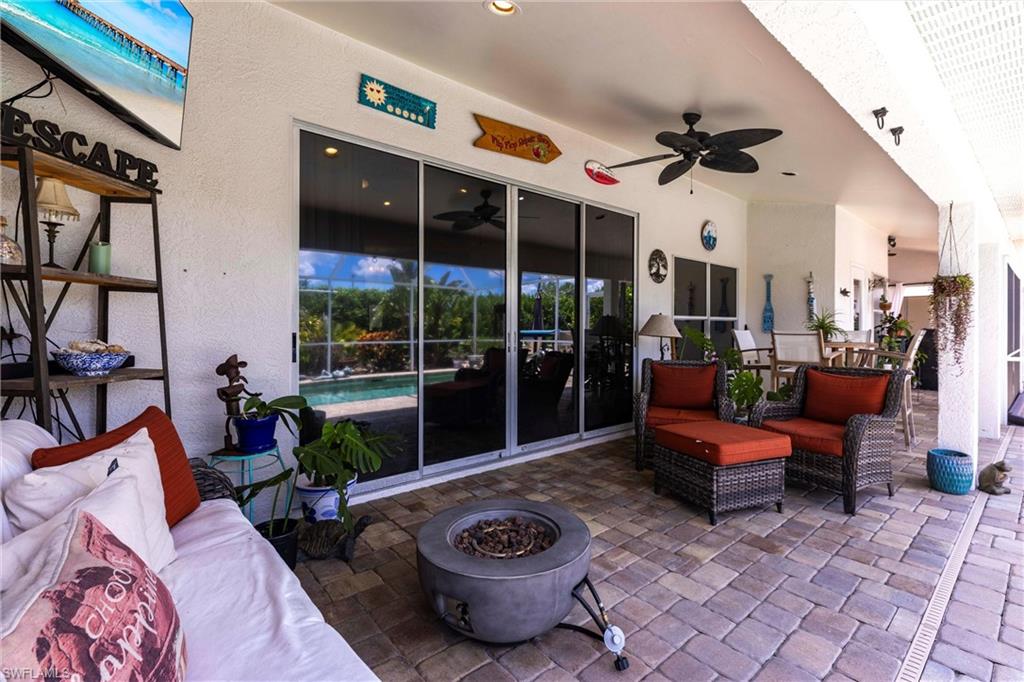 6769 Berwick Place Naples, FL 34104 - Photo 12 of 21 a living room with furniture and a floor to ceiling window