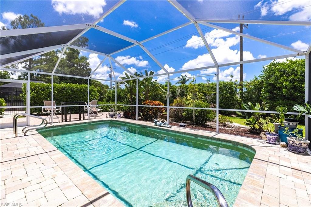 6769 Berwick Place Naples, FL 34104 - Photo 16 of 21 a view of a swimming pool with a patio