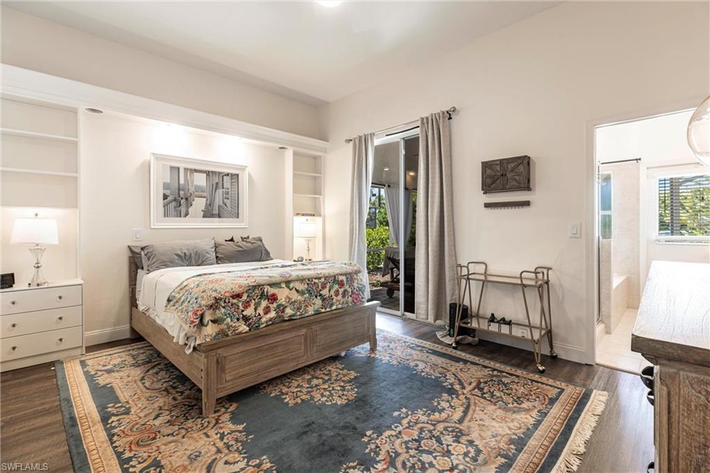 6769 Berwick Place Naples, FL 34104 - Photo 7 of 21 a bedroom with a bed a rug and a window