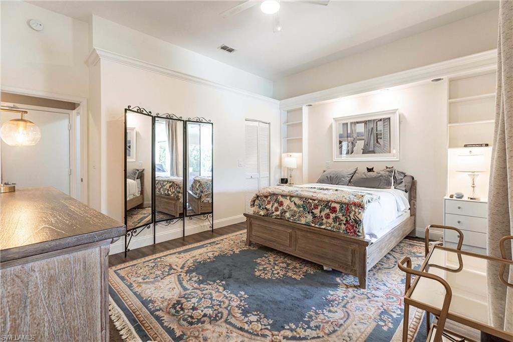 6769 Berwick Place Naples, FL 34104 - Photo 8 of 21 a bedroom with a bed a table and with the view of bathroom