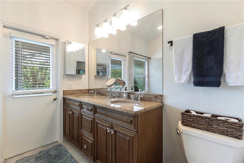 6769 Berwick Place Naples, FL 34104 - Photo 9 of 21 a kitchen with a sink stove and cabinets