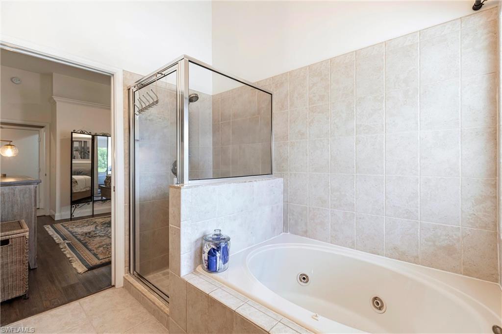 6769 Berwick Place Naples, FL 34104 - Photo 10 of 21 a bathroom with a bathtub and a shower