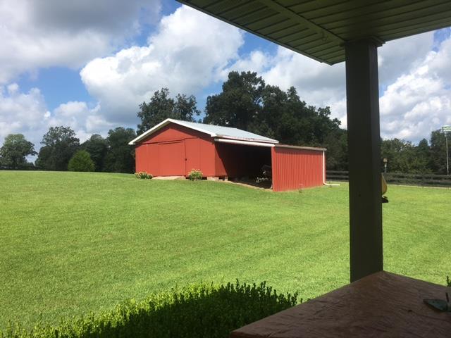 3343 Knight Road Woodlawn, TN 37191 - Photo 21 of 29 View of the 24 x 24 storage building. Also, carport area. Plenty of room for farm equipment or extra cars and boat.
