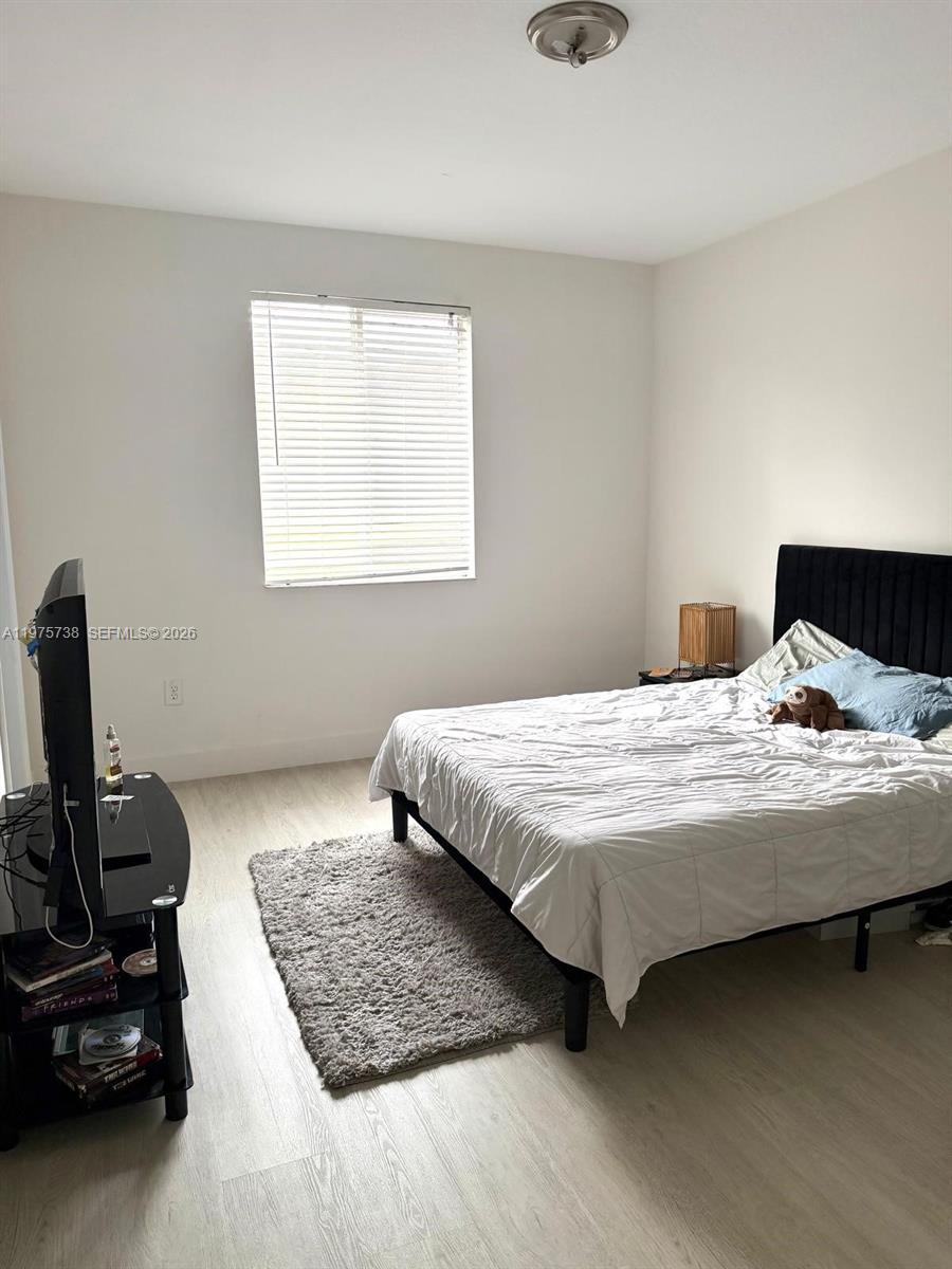 11269 Southwest 231st Lane Miami, FL 33170 - Photo 15 of 19 a bedroom with a bed and a window
