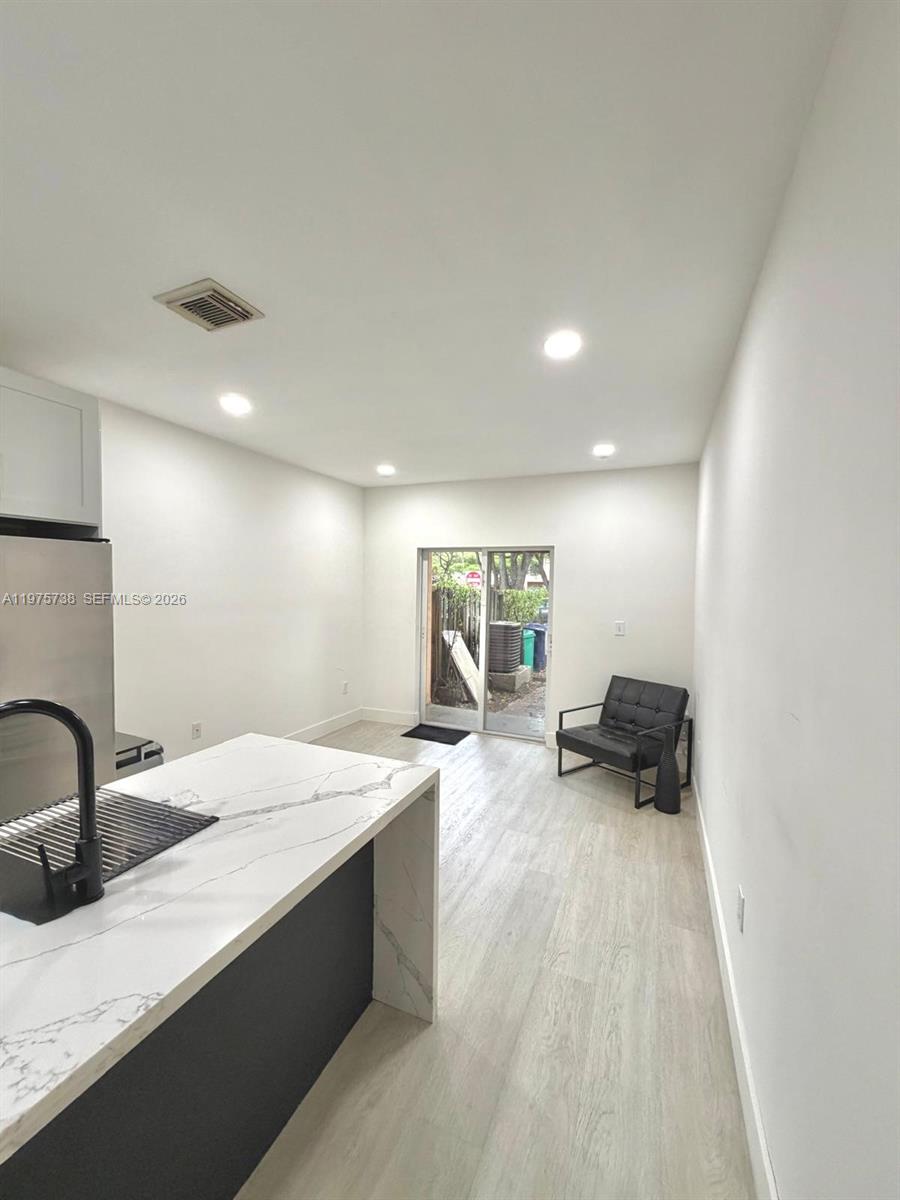 11269 Southwest 231st Lane Miami, FL 33170 - Photo 4 of 19 a large white kitchen with a sink and couch