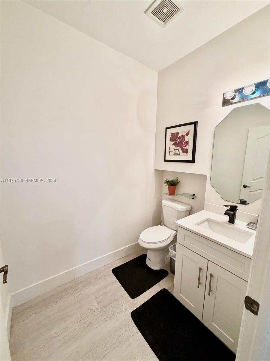 11269 Southwest 231st Lane Miami, FL 33170 - Photo 5 of 19 a bathroom with a toilet sink and mirror