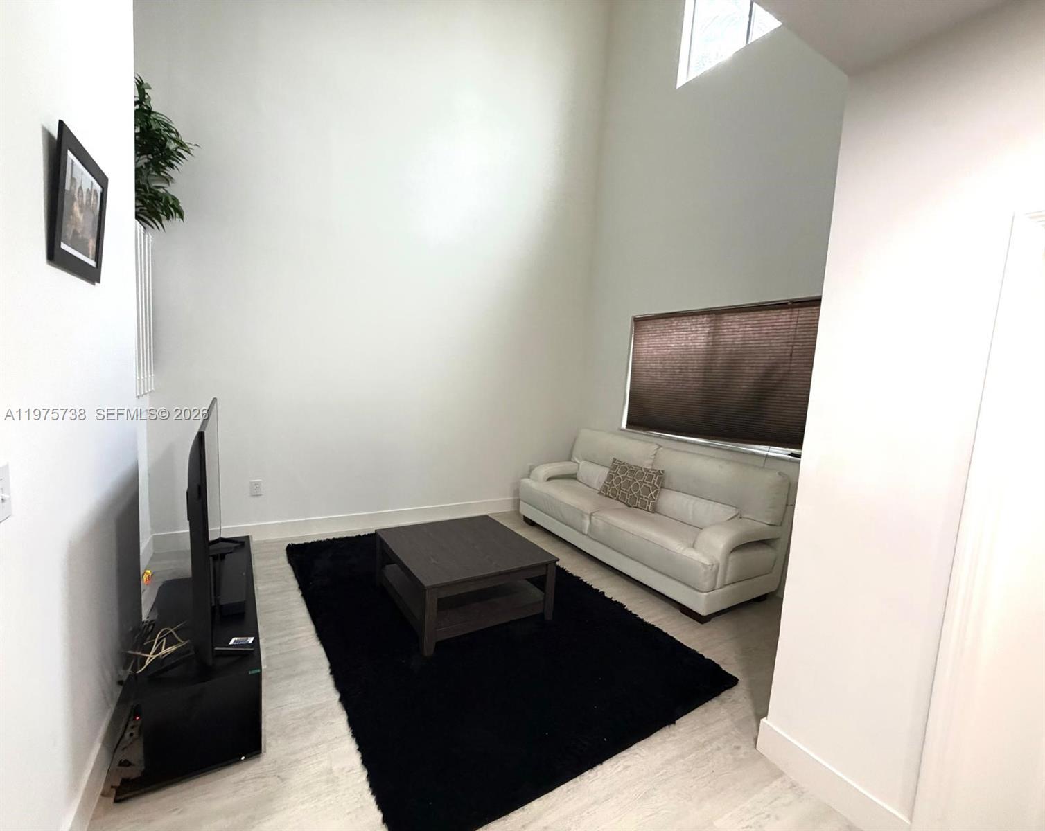 11269 Southwest 231st Lane Miami, FL 33170 - Photo 6 of 19 a living room with furniture and a flat screen tv