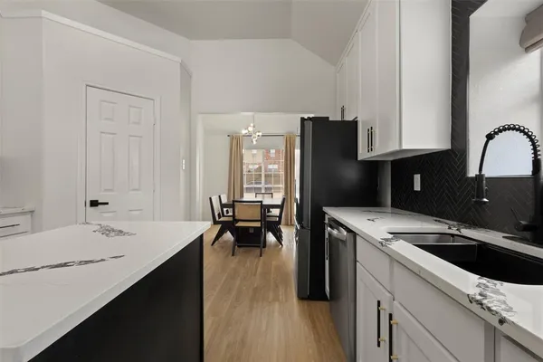 a kitchen with a sink a stove and refrigerator