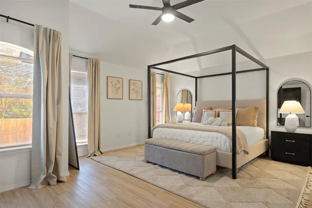 a bedroom with a bed and a mirror